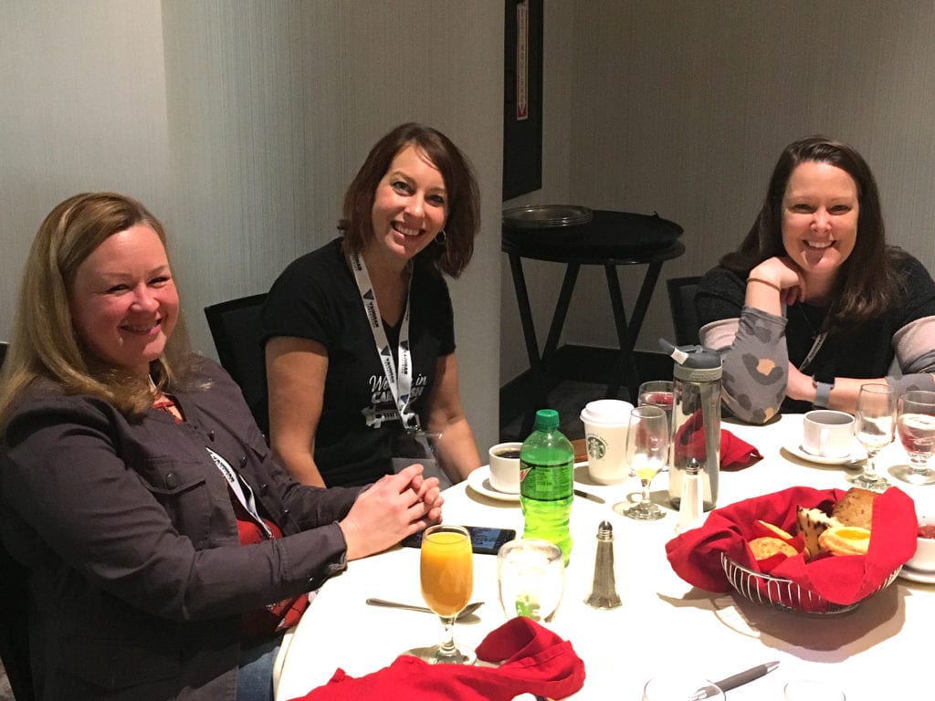 Women eating at table car wash conference