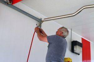 man repairing a car wash boom