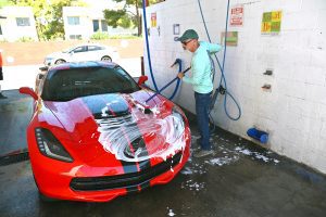 man using a self serve car wash