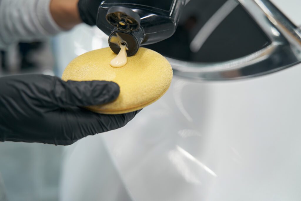 Applying wax using an applicator pad.