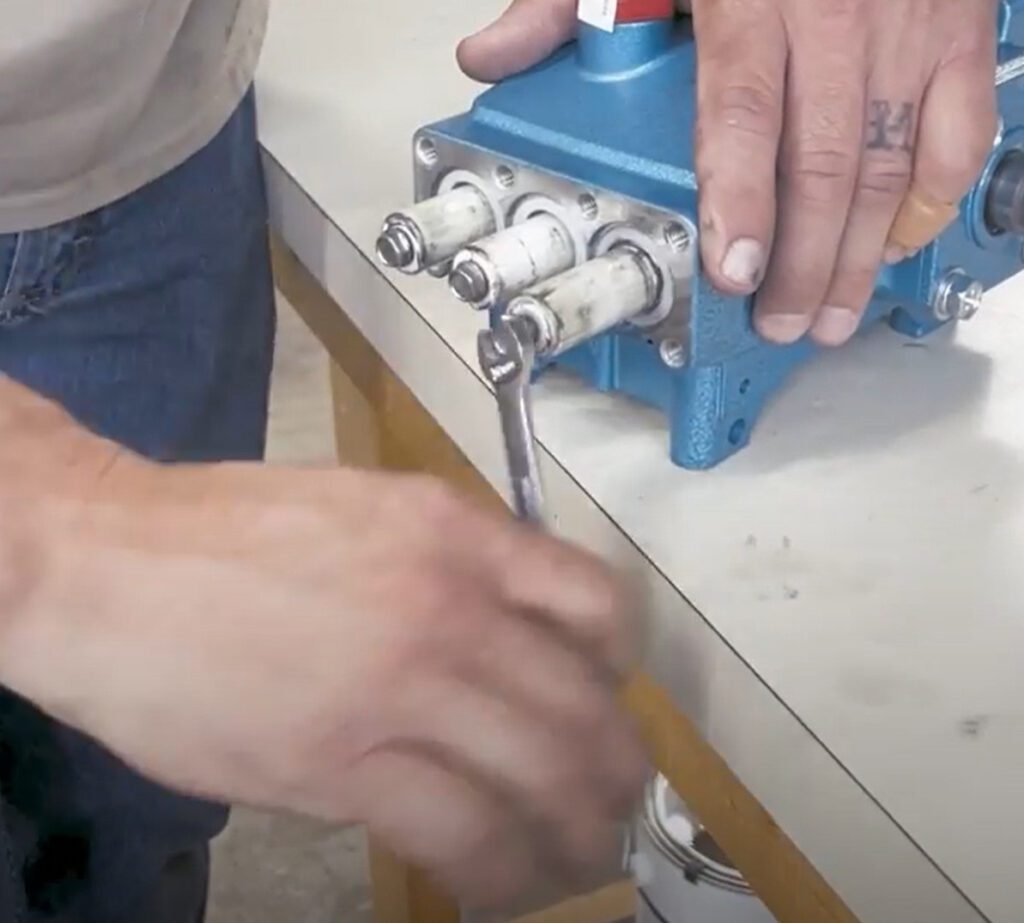 Removing the bolt that holds on the plunger.