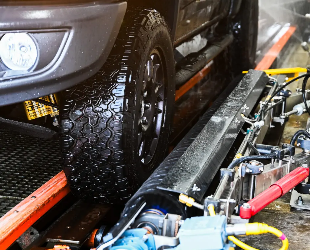A tire dressing applicator brush applies tire shine to a truck.